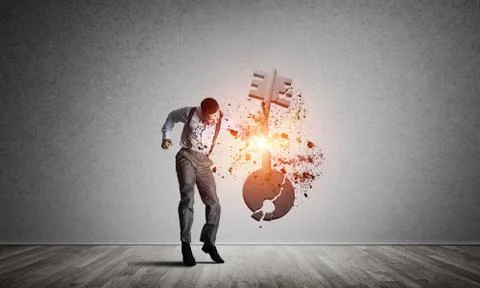 Breaking through access concept with man in room crashing concrete key Stock Photos