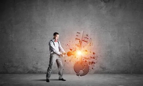 Breaking through access concept with man in room crashing concrete key 스톡 사진