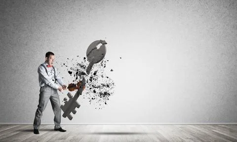 Breaking through access concept with man in room crashing concrete key Stock Photos