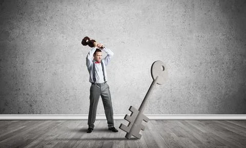 Breaking through access concept with man in room crashing concrete key Stock Photos
