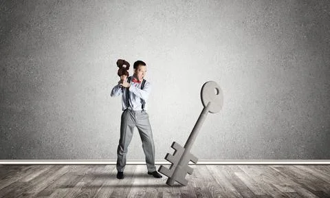 Breaking through access concept with man in room crashing concrete key 스톡 사진