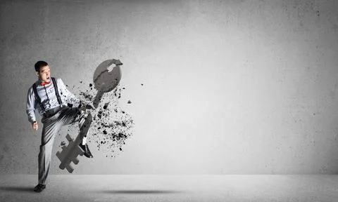 Breaking through access concept with man in room crashing concrete key Det... Foto stock