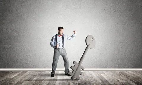 Breaking through access concept with man in room crashing concrete key 写真素材