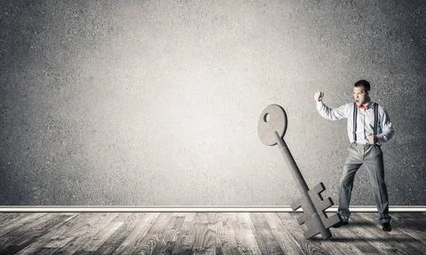 Breaking through access concept with man in room crashing concrete key Det... Foto stock