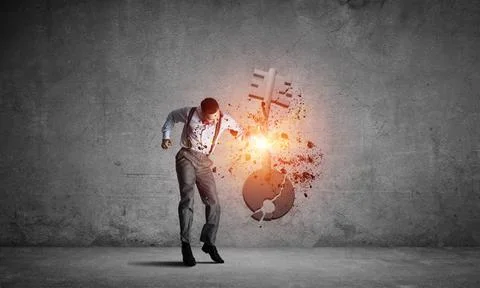 Breaking through access concept with man in room crashing concrete key Det... 스톡 사진