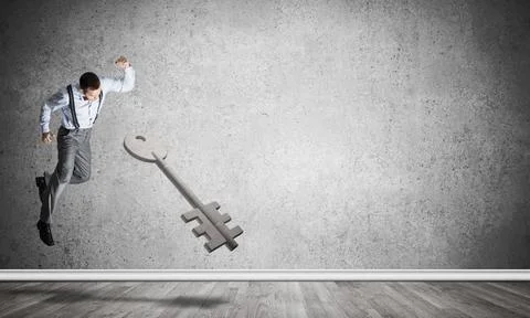 Breaking through access concept with man in room crashing concrete key Det... 스톡 사진