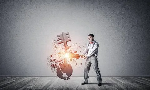 Breaking through access concept with man in room crashing concrete key Det... 스톡 사진