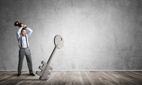 Breaking through access concept with man in room crashing concrete key Stock Photos