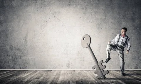 Breaking through access concept with man in room crashing concrete key Det... 스톡 사진