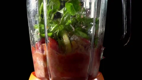 Breaking tomatoes and herbs in a blender. Obtaining tomato pulp . The stage o Stock Footage 158981069