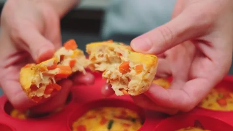 Breaking a vegetable muffin with cheese into two parts Stock-Footage 252376517