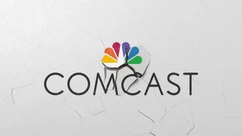 Breaking wall with painted logo of Comcast. Crisis related editorial 3D Stock Illustration