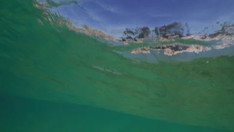 Breaking Wave Churns White Bubbles Beneath Turquoise Ocean Surface Stock Footage 344380167