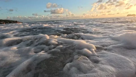 Breaking wave crashes to camera at sunset-Low angle Stock Footage 229910877