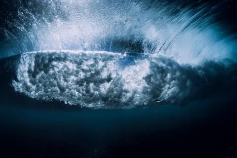 Breaking wave with foam and bubbles underwater. Transparent ocean water Stock Photos