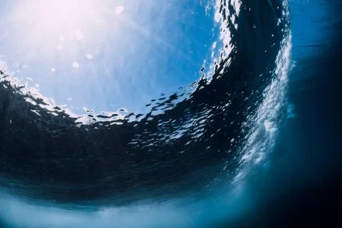 Breaking wave with foam and bubbles underwater. Transparent ocean water Stock Photos