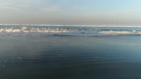 The breaking wave rolls beautifully on the sandy beach and breaks with foam  Stock Footage 168496310