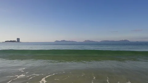 Breaking wave Samil Beach with Cies islands in the background Stock Footage 130120871