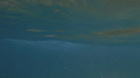 Breaking wave under the water / slow-motion from underwater / 4K 120p Stock Footage 121859839