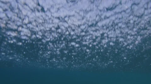 Breaking wave under the water / slow-motion from underwater / 4K 120p Stockbeeldmateriaal 121859989