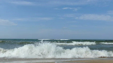 Breaking of waves at baltic sea beach blue sky 4k Stockbeeldmateriaal 124835744