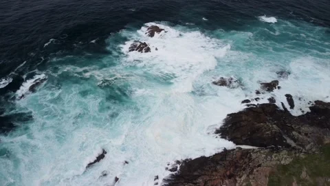 Breaking Waves Onto Rugged Shore With Foamy Surface In Caion Beach Stock Footage 237063844