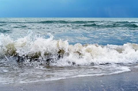 Breaking waves on sea before thunderstorm Stock Photos