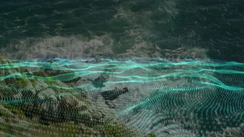 Breaking waves starting cyan dotted grid sweeping over rocky nearshore, showing Stock Footage 329433670