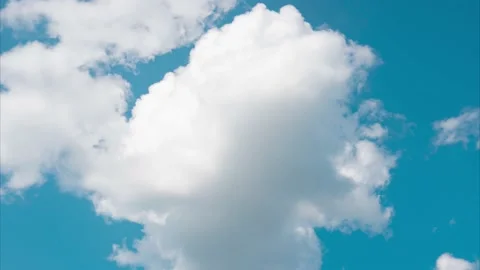 A breaking white cloud in the blue sky on a sultry summer day. 4k time-lapse. Stock Footage 159813813