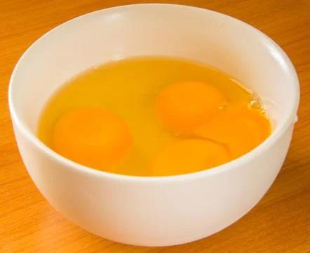 The breaks egg in a cup Stock Photos