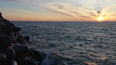 Breakwater and waves at the sunset Stock Footage 260370901
