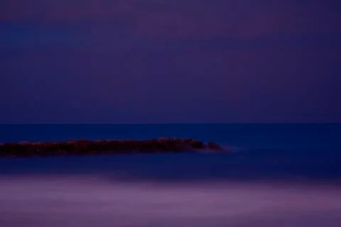 Breakwater on the beach at dusk Stock Photos