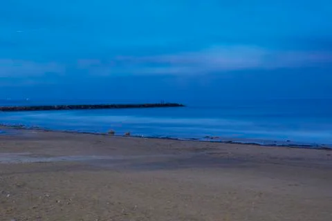 Breakwater on the beach at dusk Stock Photos