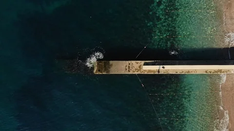 Breakwater on beachfront with turquoise ocean water horizontal aerial view Stock Footage 104256782