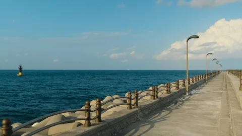 A breakwater path where you can walk while looking at the sea. Beautiful sky, cl Stock Footage 119509746