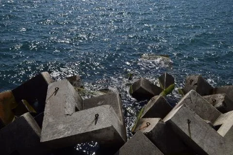 Breakwater of the rectangular stone figures. Stock Photos