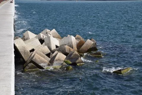 Breakwater of the rectangular stone figures. Stock Photos