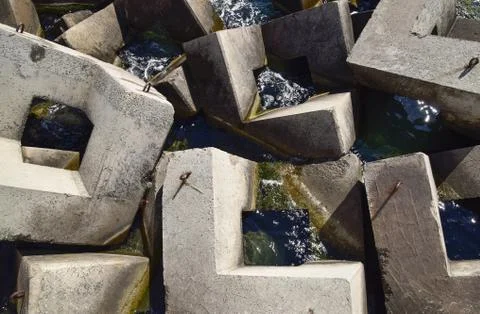 Breakwater of the rectangular stone figures. Stockfoto's