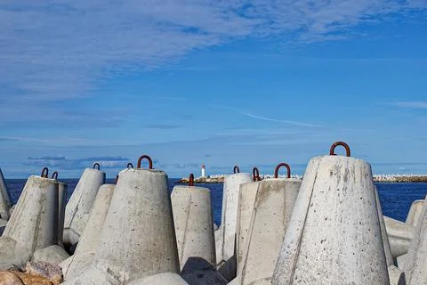 Breakwaters are concrete figured structures. The road to the lighthouse in Ve Stock Photos