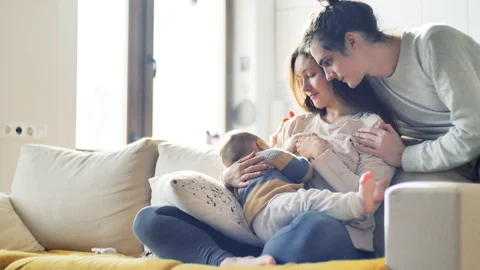 Breastfeeding Young parents look Stock Video Pond5