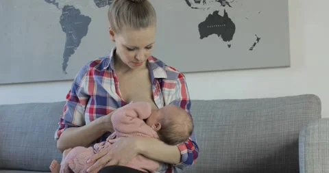 Breastfeeding mom convinces fussy baby Stock Video Pond5