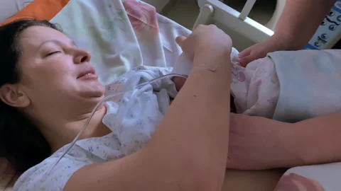 Breastfeeding within the first hour after birth, mom breastfeeding baby Stock Footage 151080829