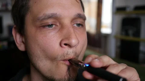 Breathing out a thick dense smoke in slow motion of electronic cigarette Stock Footage 61690167