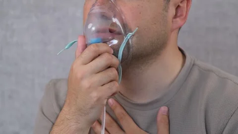Breathing with oxygen mask Stock Footage 277693736