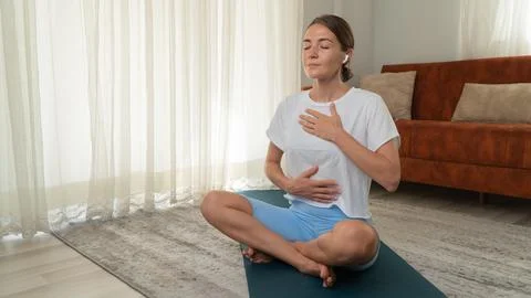 Breathing practice from yoga - a woman breathes and meditates Stock Photos