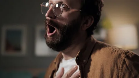 Breathing problems. Bearded man at night with asthma attack. Millennial panic 動画素材 196202723