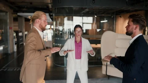 Breathing techniques in a team of office workers. A girl in a white suit and a 스톡 동영상 250602617