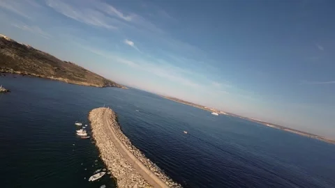Breathtaking action shot by FPV drone over the pier of the island of Gozo Stock Footage 248707257