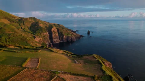 Breathtaking aerial drone perspective of a rugged coastline at golden hour Stockbeeldmateriaal 336221489