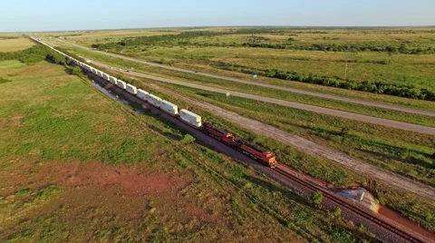 Breathtaking aerial of a freight train passing through countryside Stock Footage 53119442